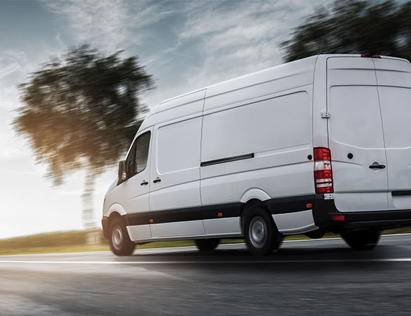 Van driving away in the sun